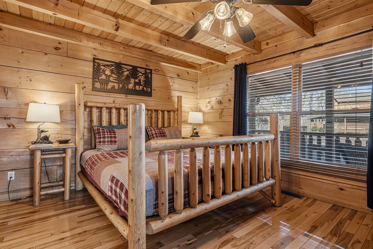 Cozy main level, king bedroom with handcrafted log bed frame, hardwood floors & rustic wildlife wall art in this Great Smoky Mountains cabin rental | Private bedroom, Sleep like a mountain king after a