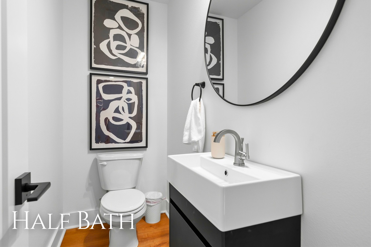 A stylish half bath with a modern vanity offers convenience for guests in the main living area.