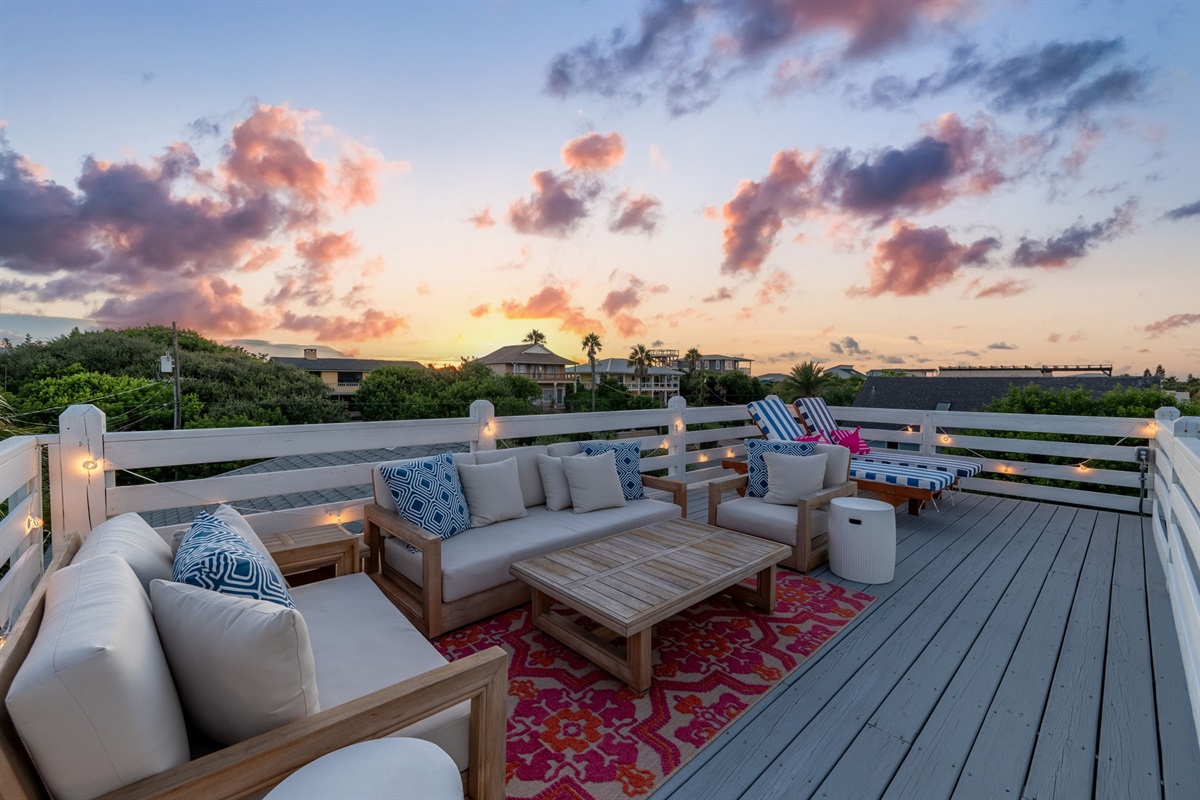 Welcome to the Eagle’s Nest deck at the top of the house! This spacious area features two striped lounge chairs and a cozy seating area with a coffee table and side tables—perfect for hanging out with a crowd or enjoying some quiet time with a view!