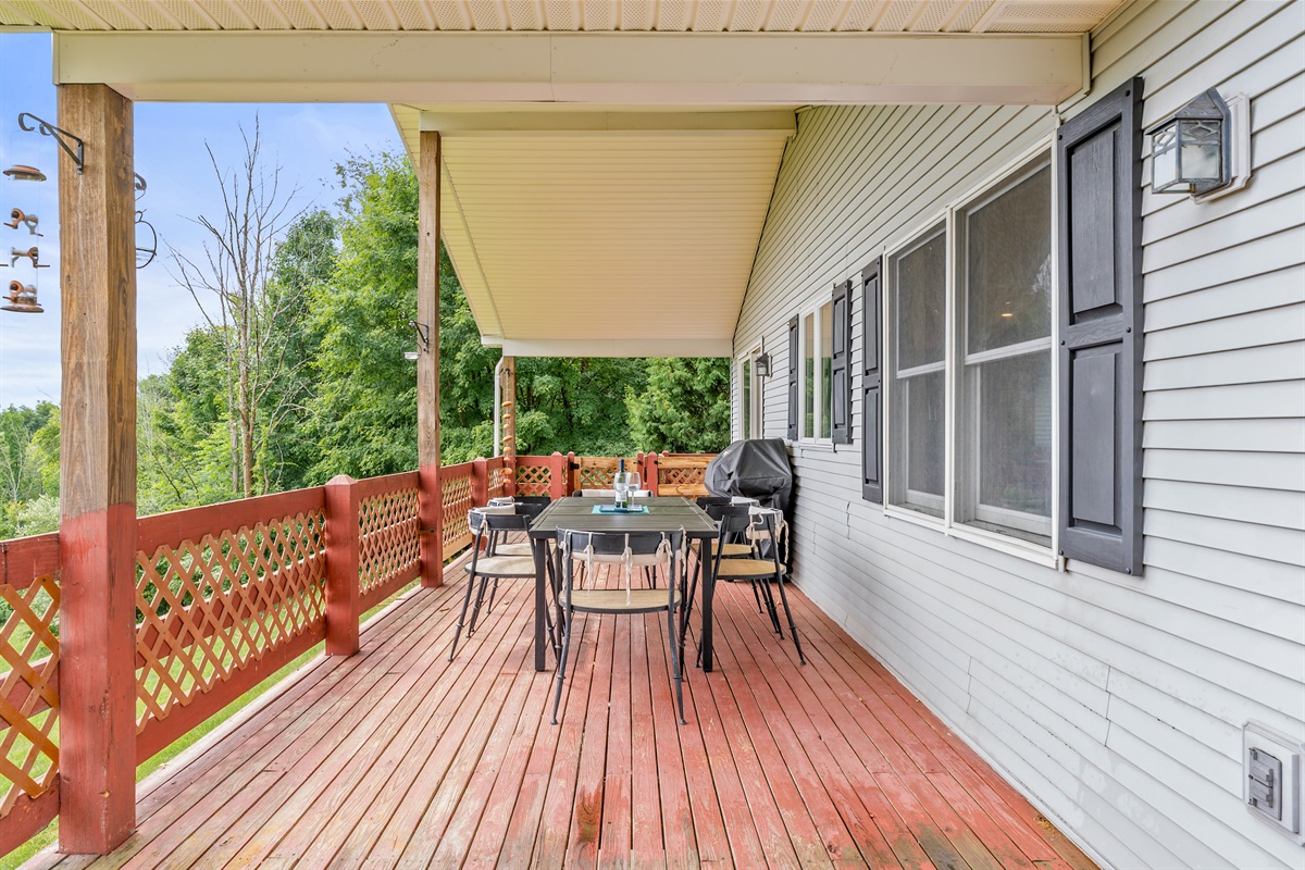 Dine al fresco or grill out in style on this private, wooded deck with charming railing details.
