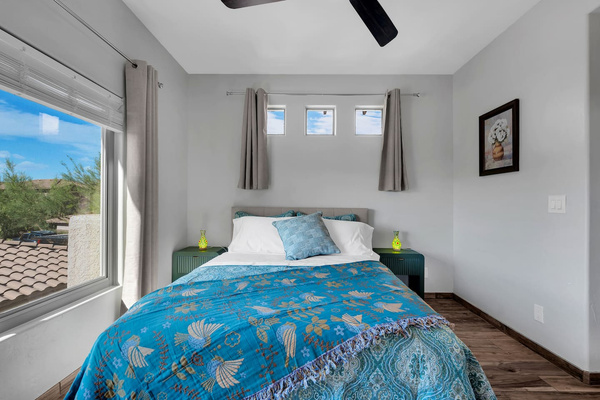 Luxurious queen bedroom with stunning mountain views, smart-TV, and work desk.