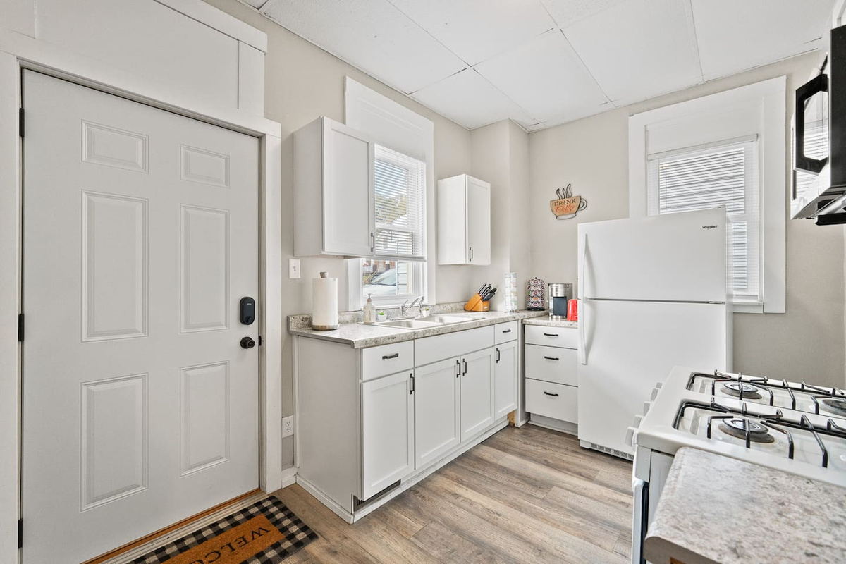 Fully equipped kitchenette with a refrigerator, stove, and microwave, perfect for preparing meals during your stay.