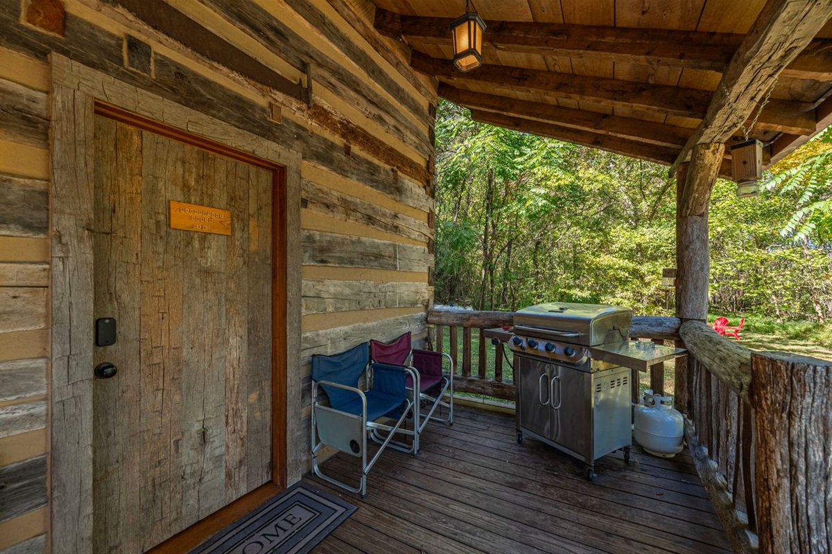 Propane gas grill on the front porch for guest use.
