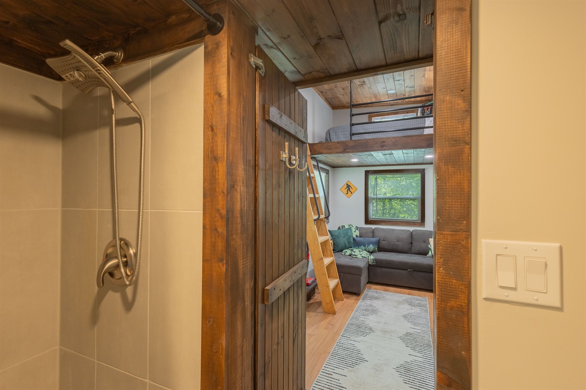 Thoughtfully designed with a full shower and easy access to the cozy living area beyond.