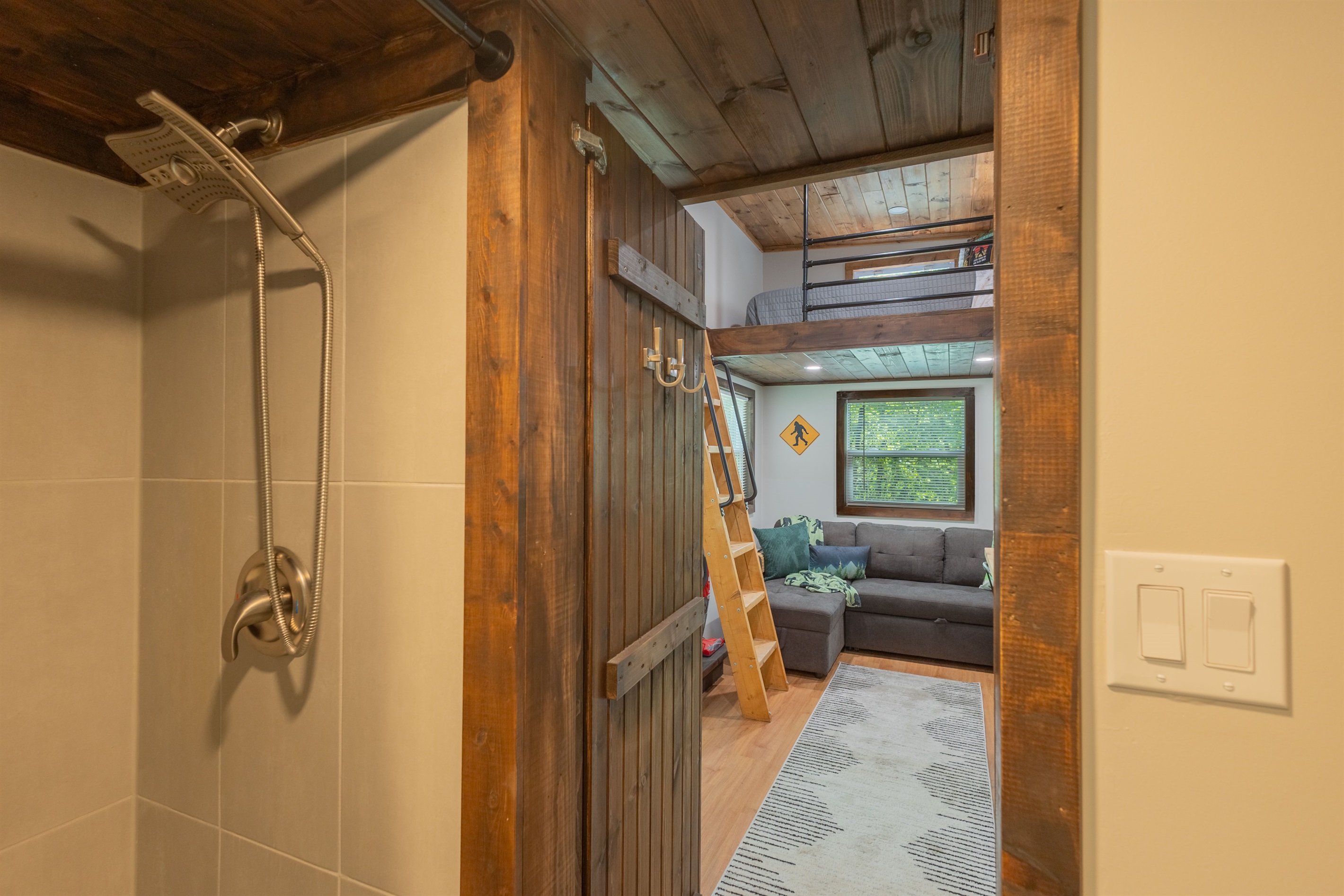 Thoughtfully designed with a full shower and easy access to the cozy living area beyond.