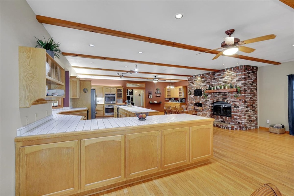 Spacious full kitchen with large gourmet island, wood cabinetry, stainless steel appliances, and plenty of prep space for group meals.