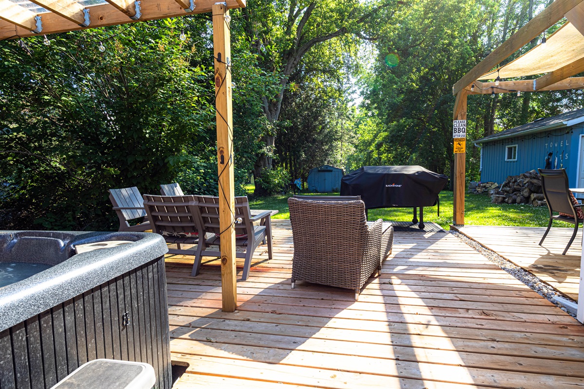 large deck with hot tub and lounge area