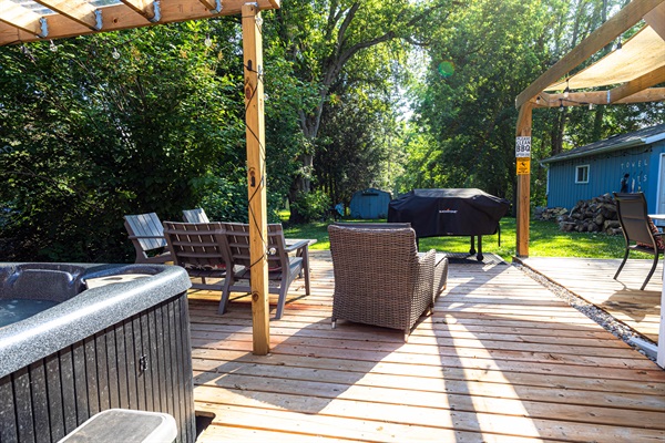 large deck with hot tub and lounge area