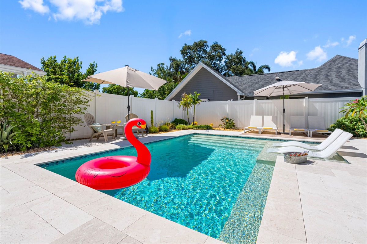 The modern rectangular pool with shallow tanning shelf and comfy loungers offers the perfect blend of style and function.