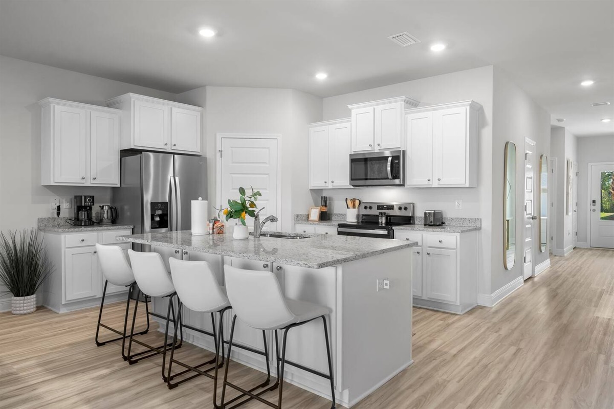 Perfect for cooking and socializing—a full kitchen with counter seating and all essential appliances.