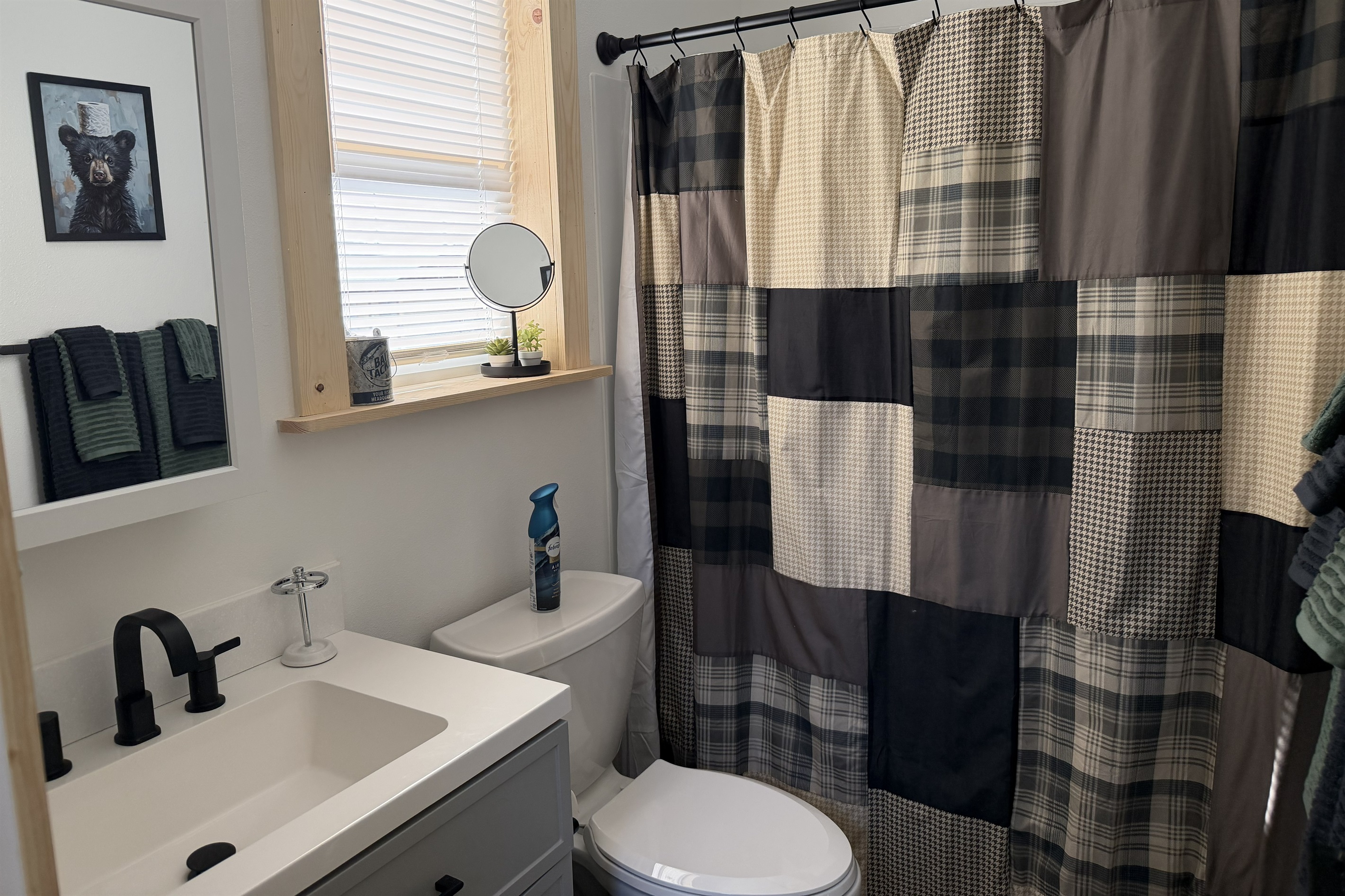 Bathroom includes a sink, toilet, and shower/tub combo.