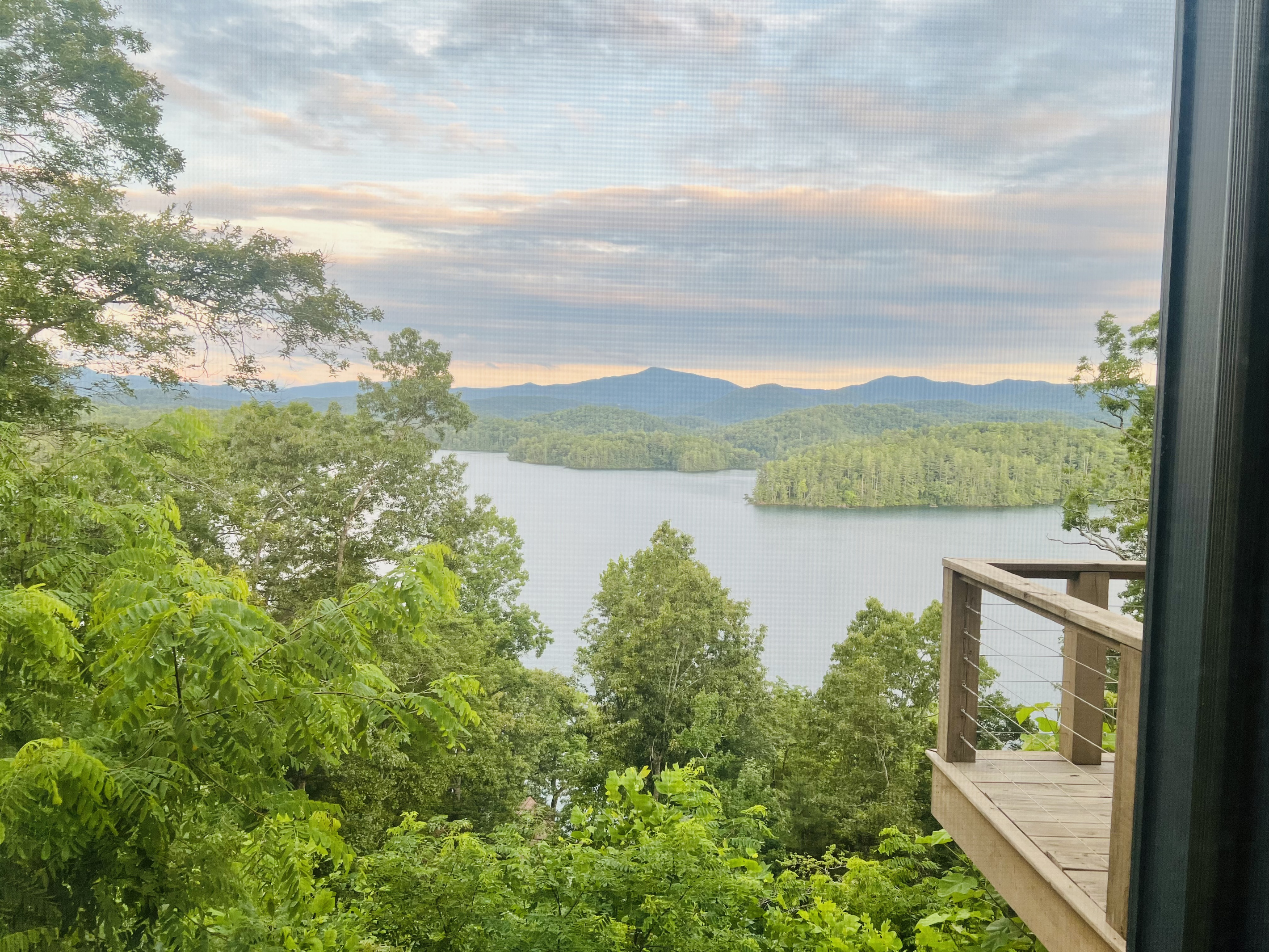 Every window frames a masterpiece. 🏞️ Hidden Point House overlooks one of North Carolina's most beautiful mountain lakes.