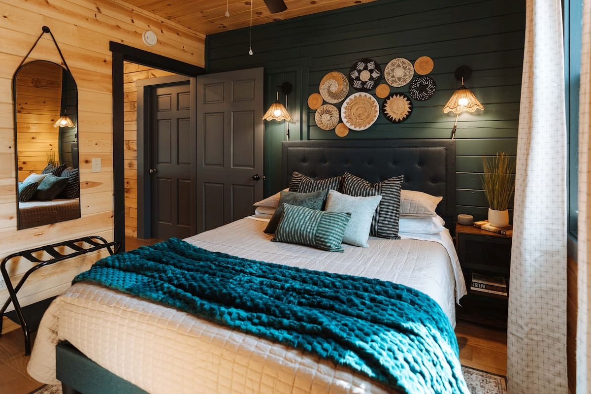 A thoughtfully curated bedroom featuring deep jewel tones