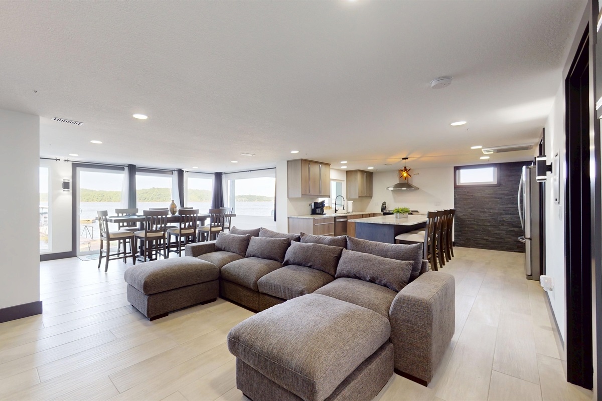 Lower Level Family Room with 85" TV sectional couch, and electric fireplace