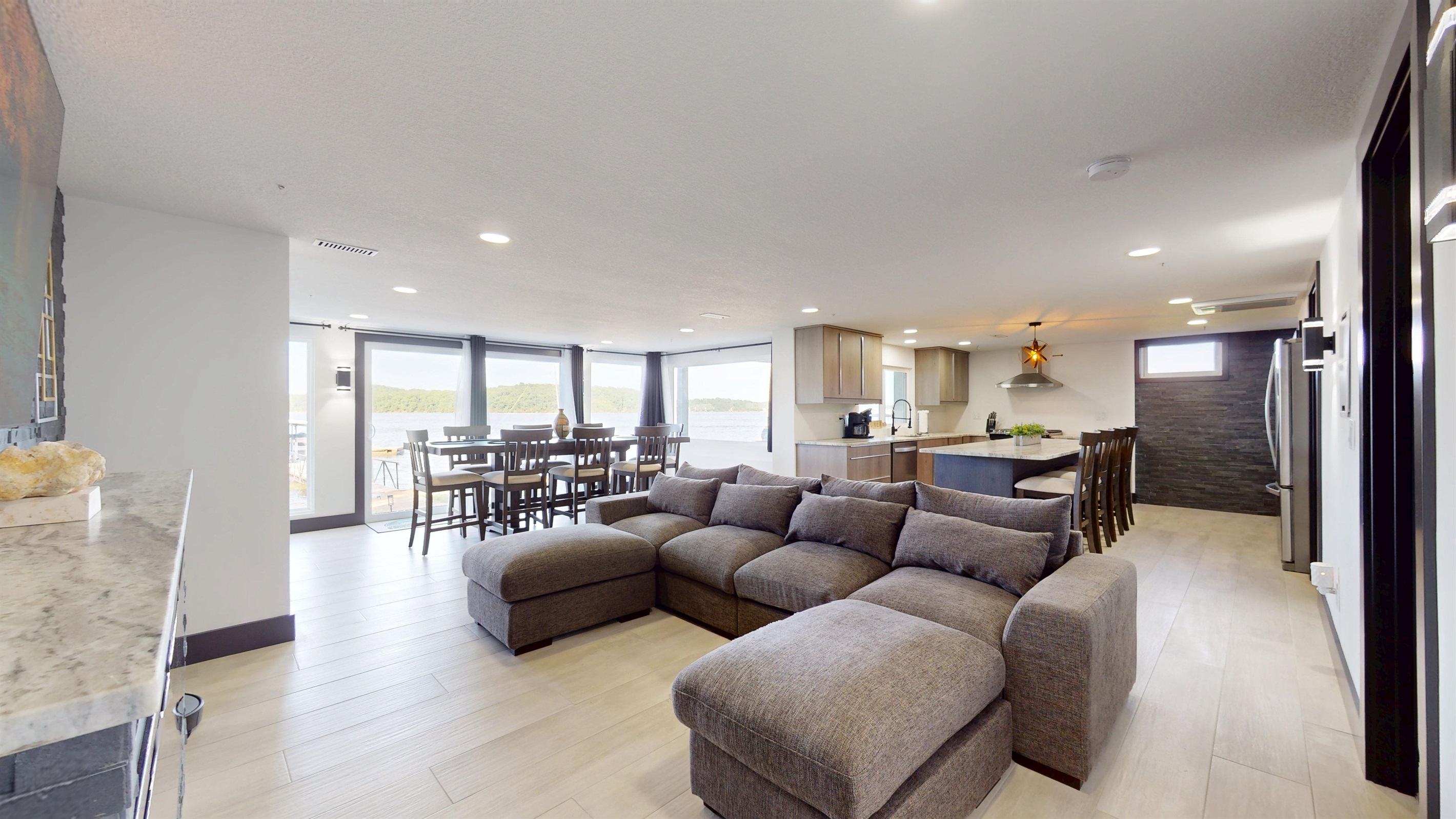 Lower Level Family Room with 85" TV sectional couch, and electric fireplace
