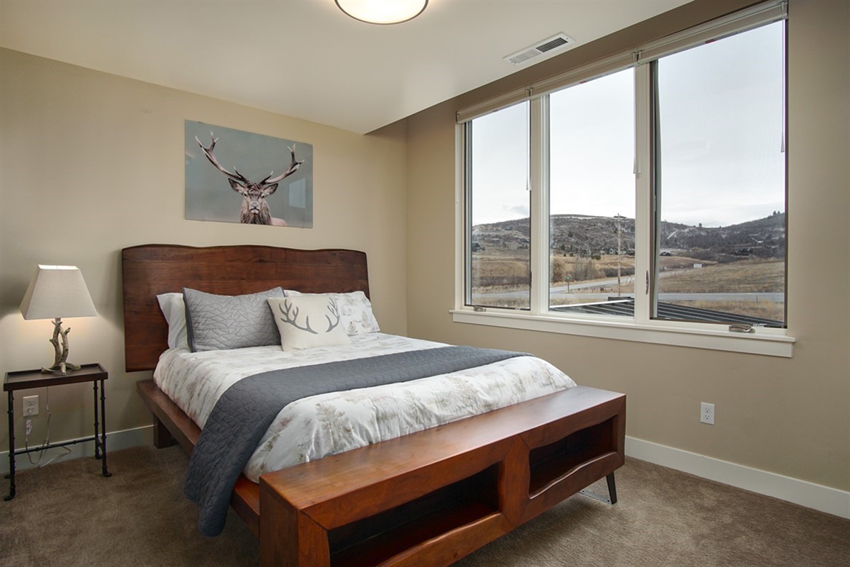 NewCozy bedroom with warm tones and relaxing views of the surrounding hills.