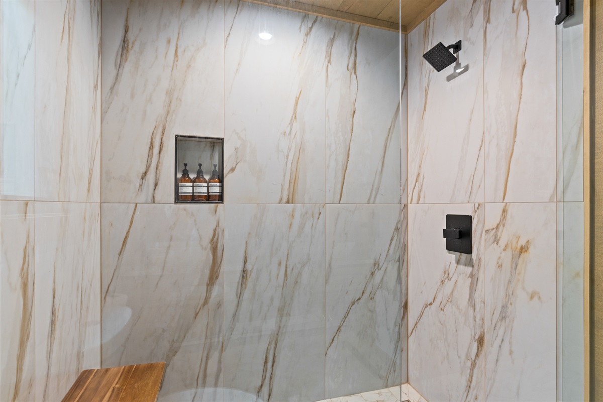 Sophisticated touches meet spa-level serenity in this marble-style shower built for true relaxation.
