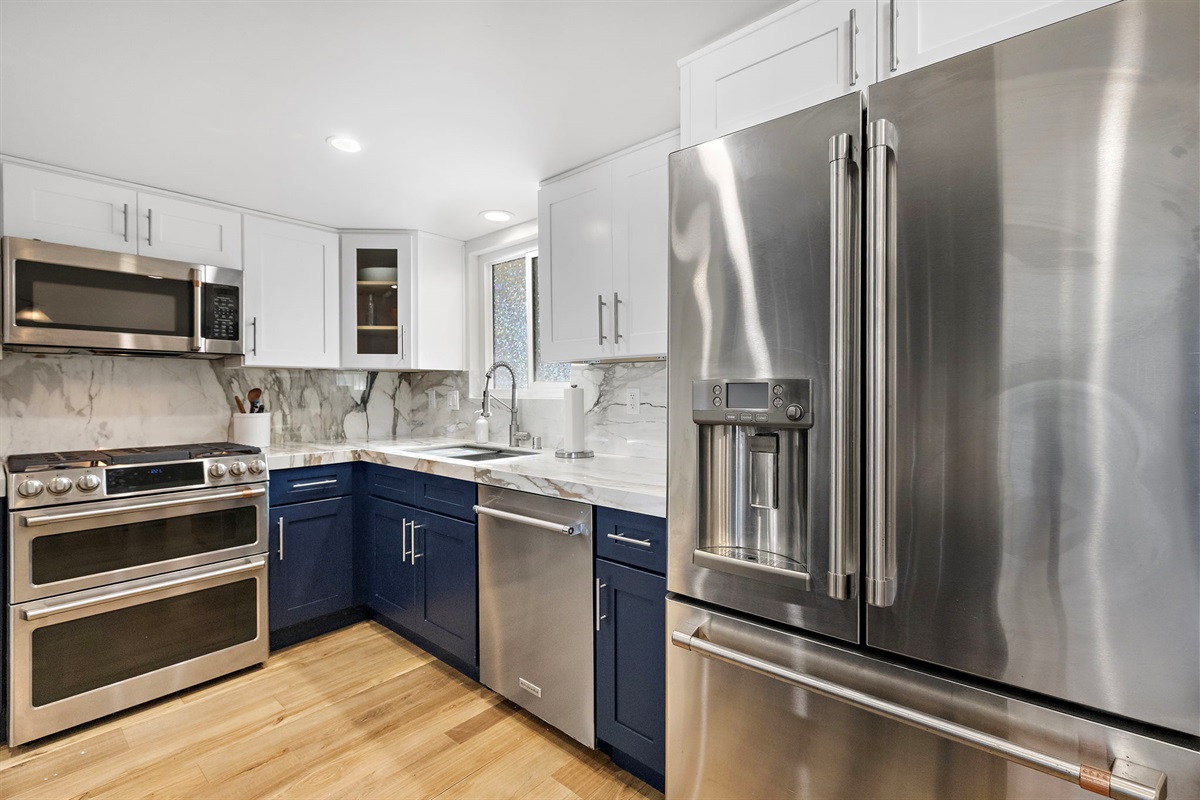 Full kitchen view highlighting premium stainless appliances, generous counter space, ample storage, and a functional layout that makes cooking easy and comfortable
