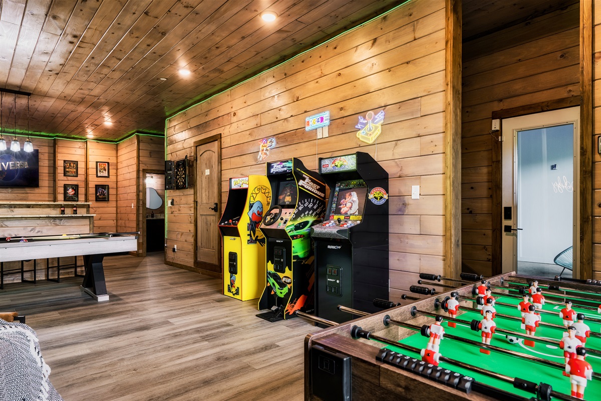 Game room with pool table, foosball table, arcades, board games, theater and half bath