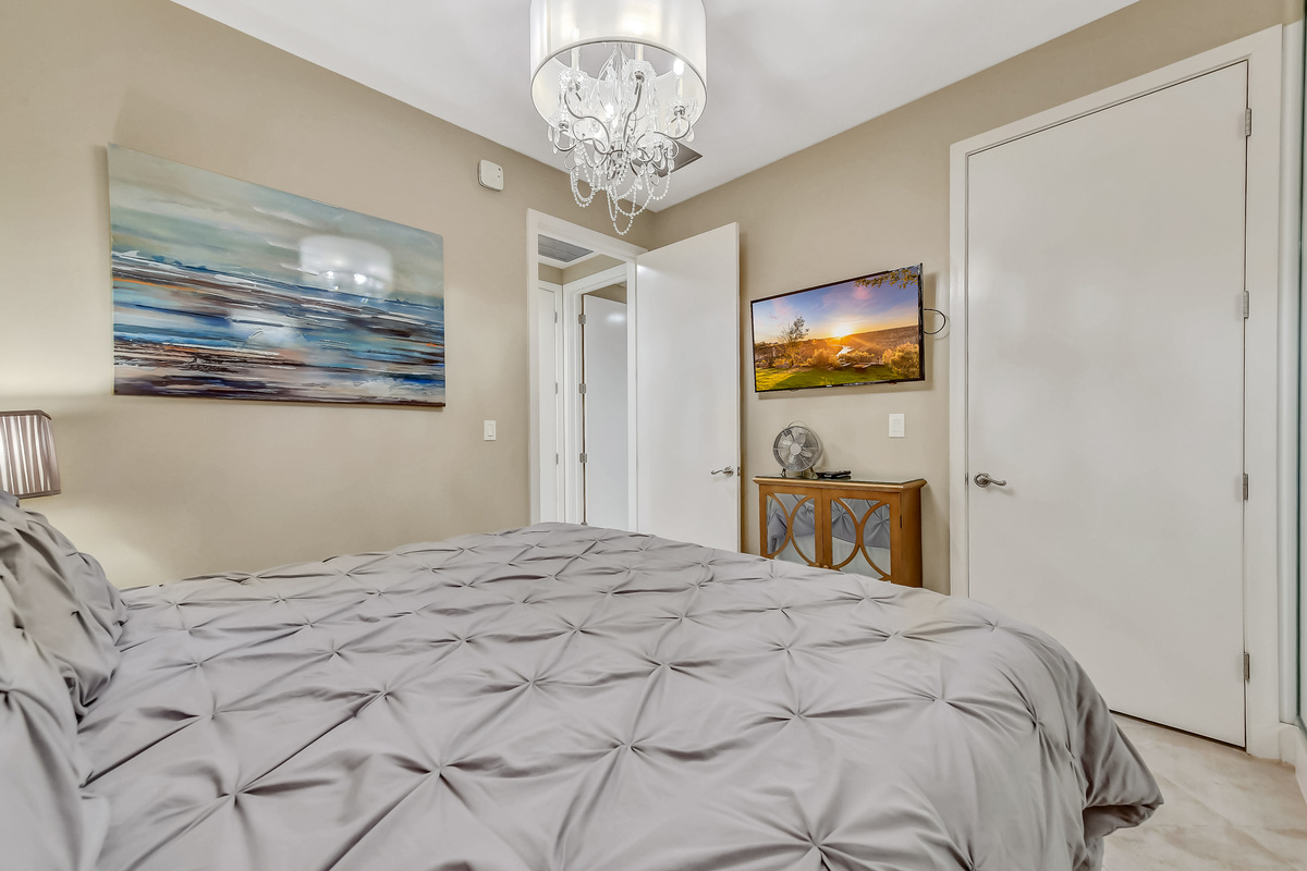 Guest bedroom with a walk-in closet and television, so you can relax in private at the end of the day.