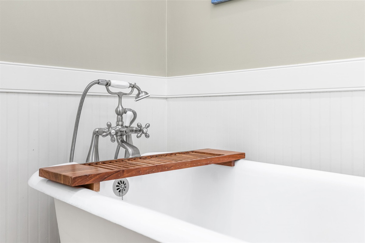 Bathroom Retreat: Unwind in a stylish soaking tub with vintage charm and modern fixtures!