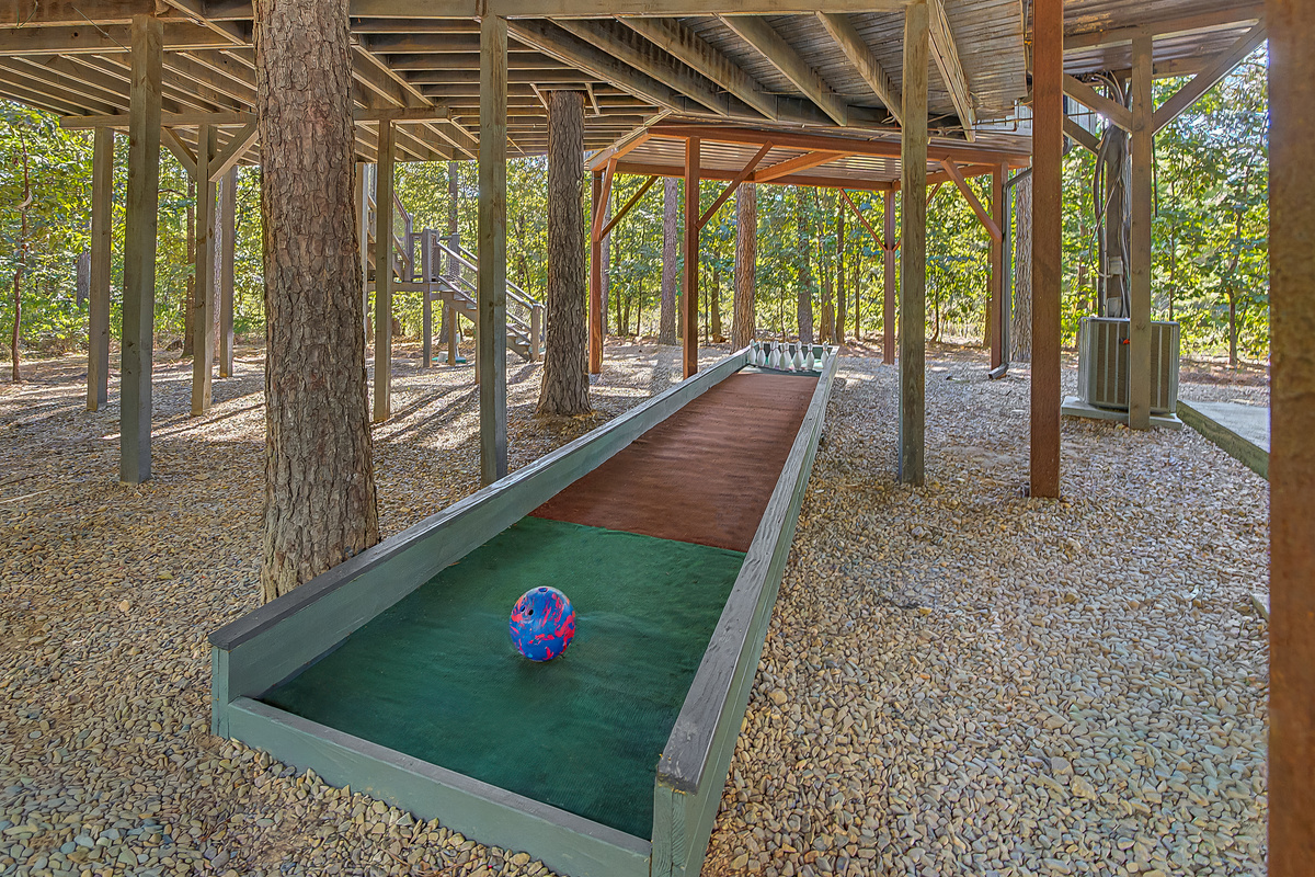 Yes, your treehouse has its own outdoor bowling lane! One of several games tucked into the huge covered play area below.