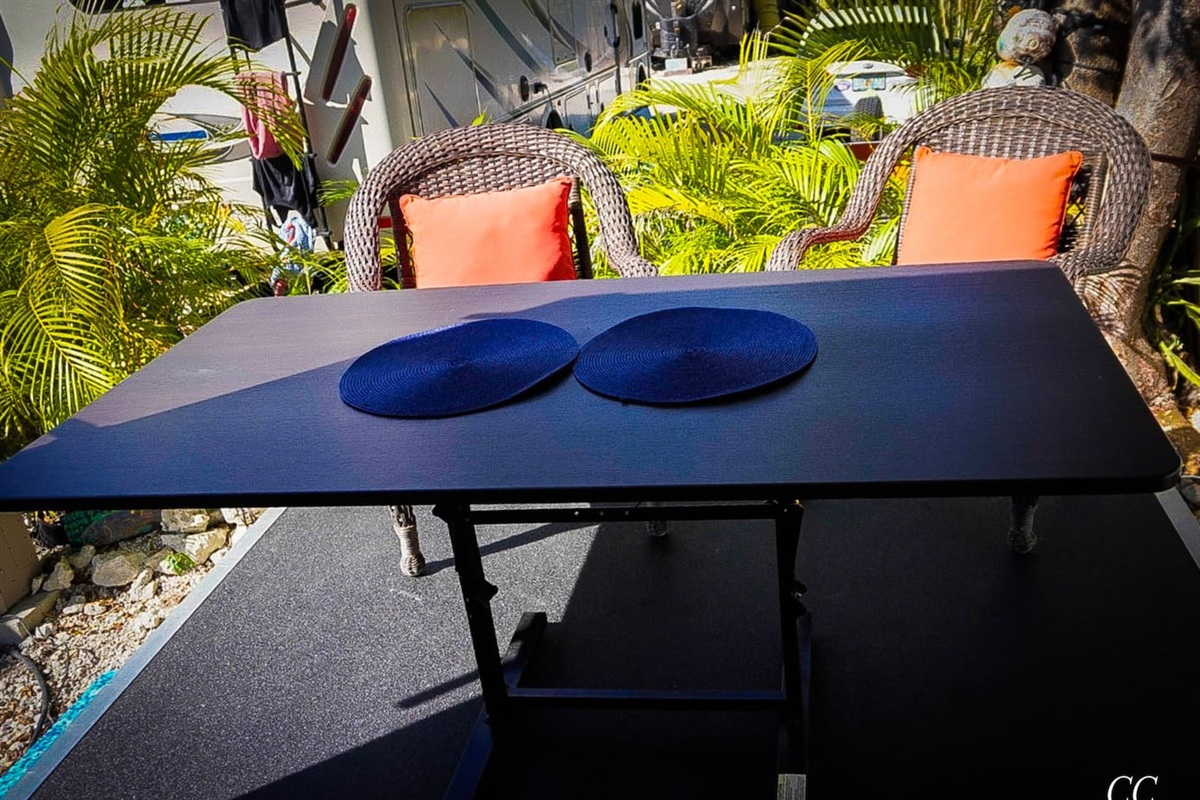 Drop the back wall for additional outside living space. Can use the outside furniture or pull some from the inside out for more space. In the compartment there is a bug screen you can put up and use if needed,