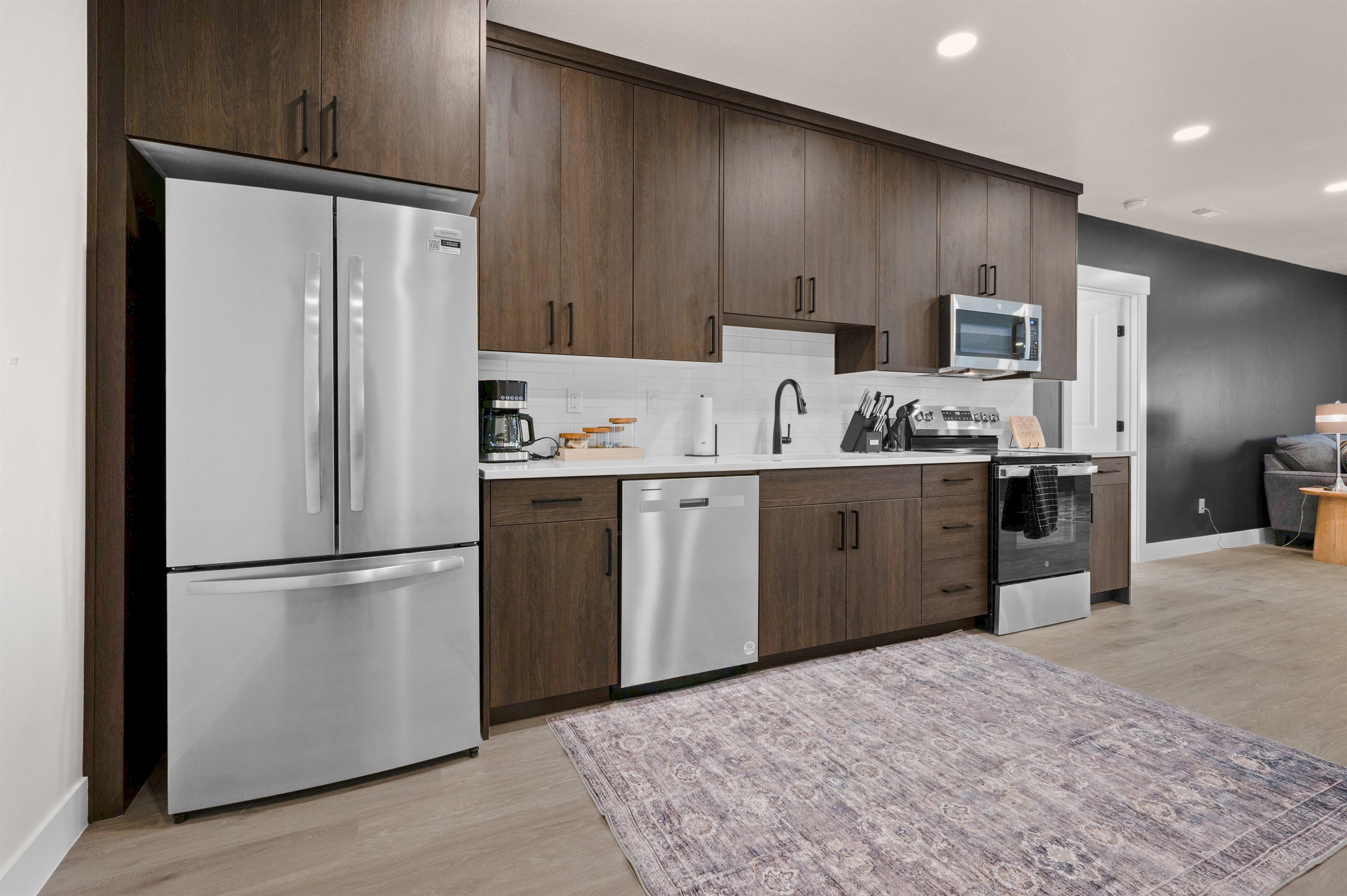 Bright, modern kitchen with quartz counters and stainless appliances.