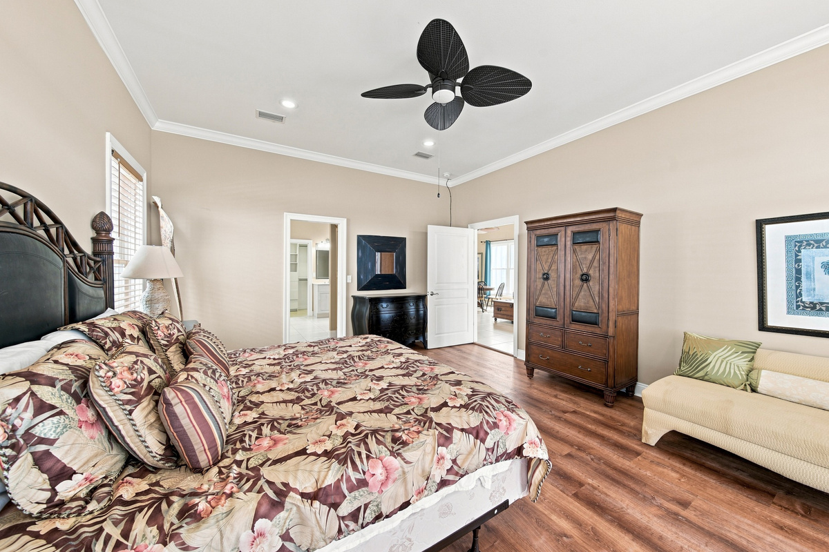 Guest bedroom with a ceiling fan and warm decor