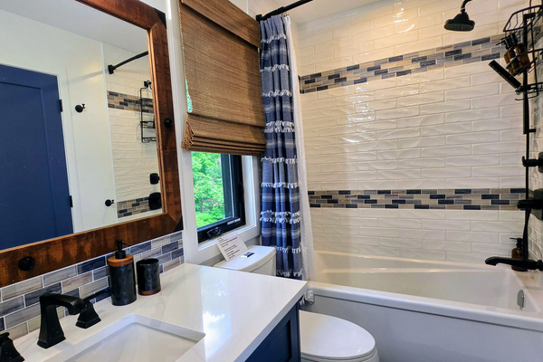 Main floor full bathroom with tub and shower