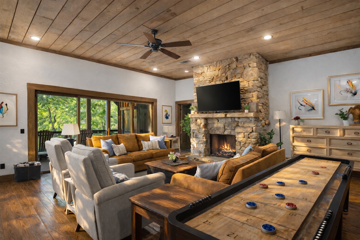 Lounge in the cozy living area&hellip; or turn up the fun with a little shuffleboard competition.
*Indoor Fireplace (Seasonal Use October - April)