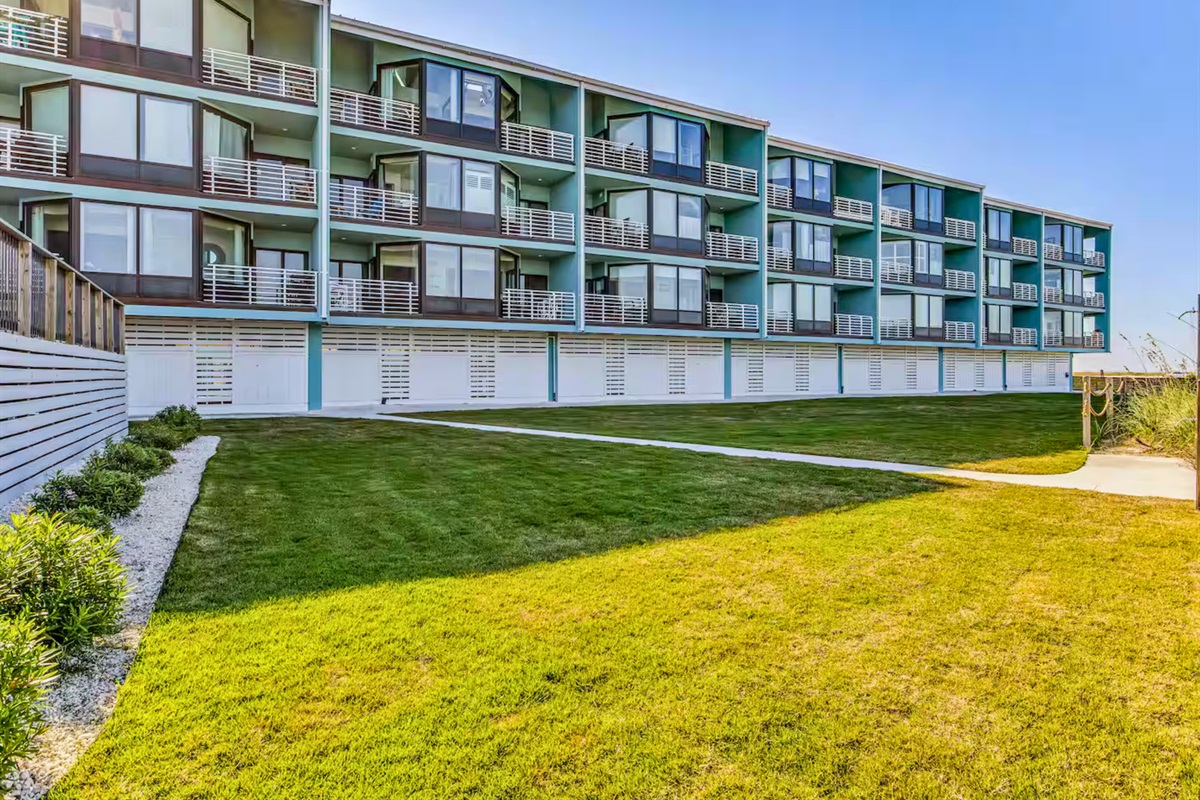 Another exterior view shows the well-kept grounds and inviting coastal setting.