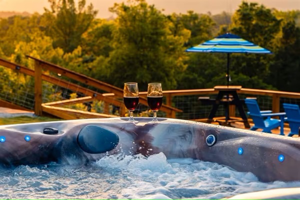 Relax in the hot tub with drinks and sunset views over the river valley.