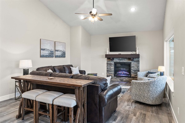 Main Level Living Room with fireplace and large TV.