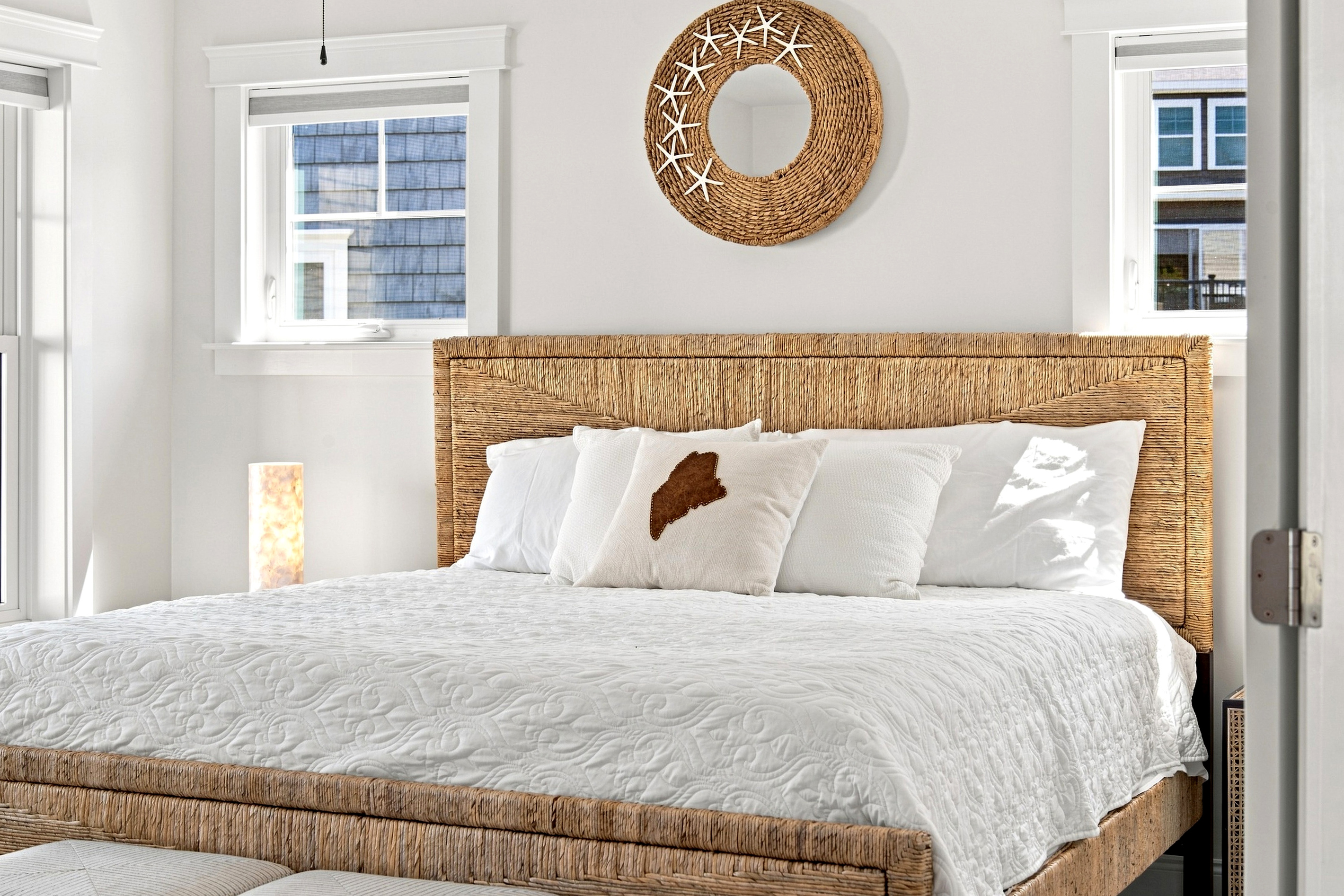 Settle into a comfortable bed surrounded by simple coastal details designed for relaxation.