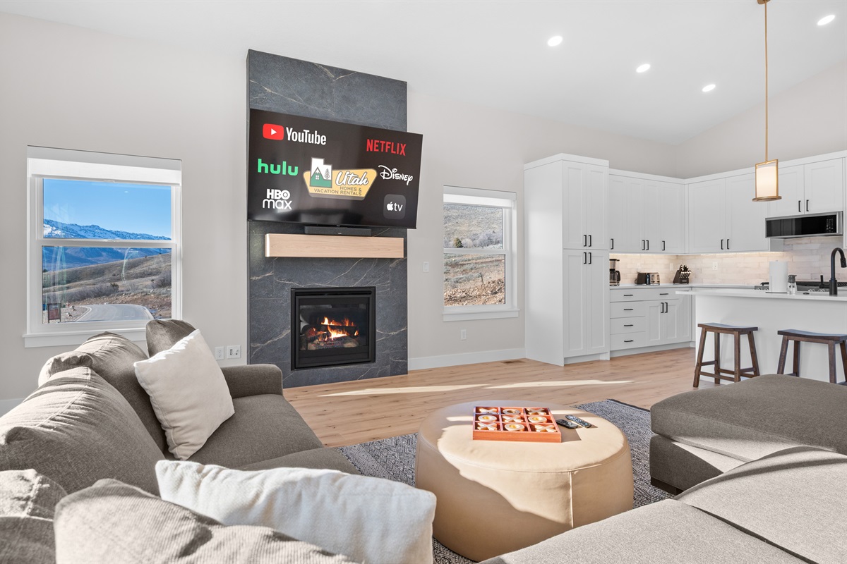 Open living and kitchen space designed for gathering, with stunning mountain views throughout.