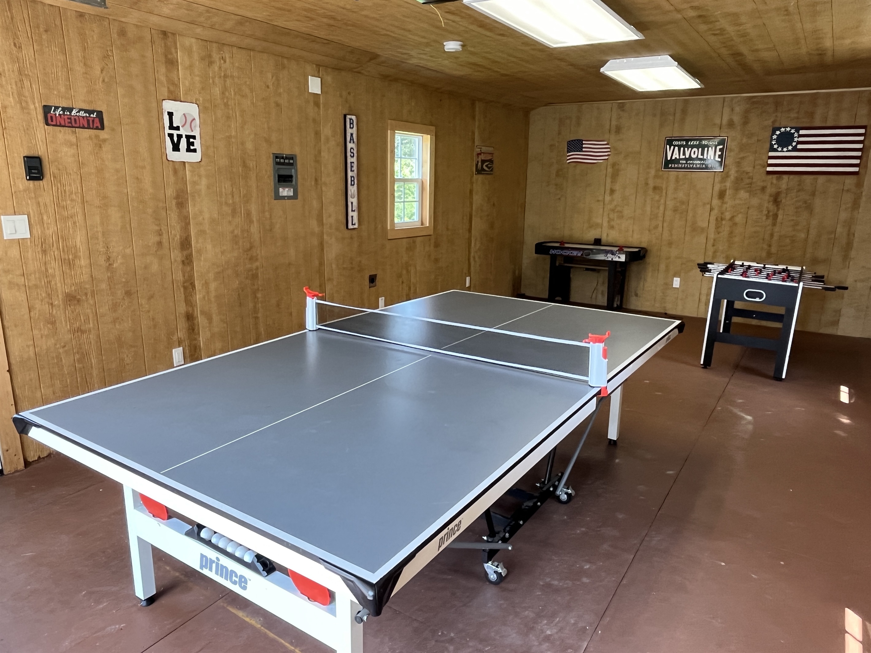 Garage game room with ping pong, foosball and air hockey.