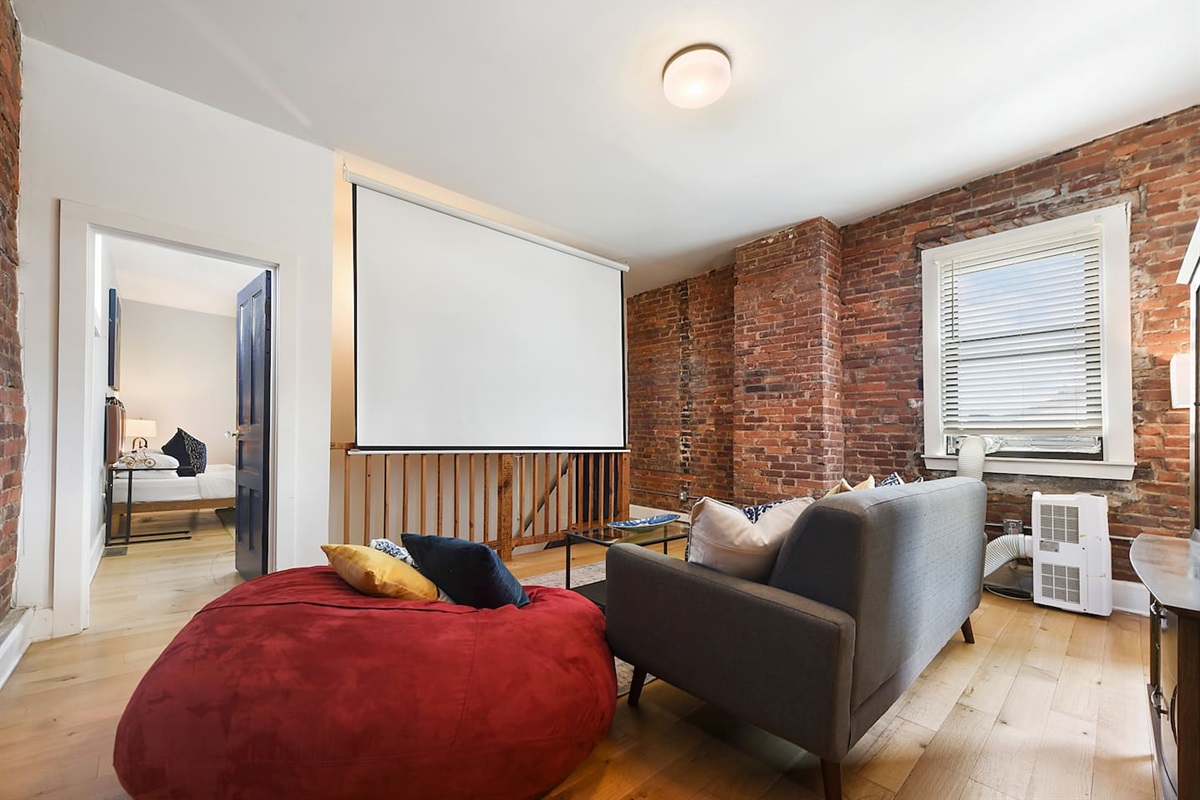 Relax in front of the theater screen on a comfy bean bag or couch