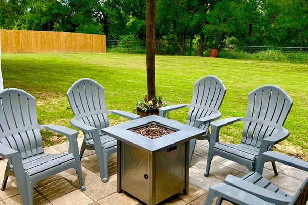 Step outside to a charming back patio with comfortable seating, perfect for sipping morning coffee or unwinding under the stars.