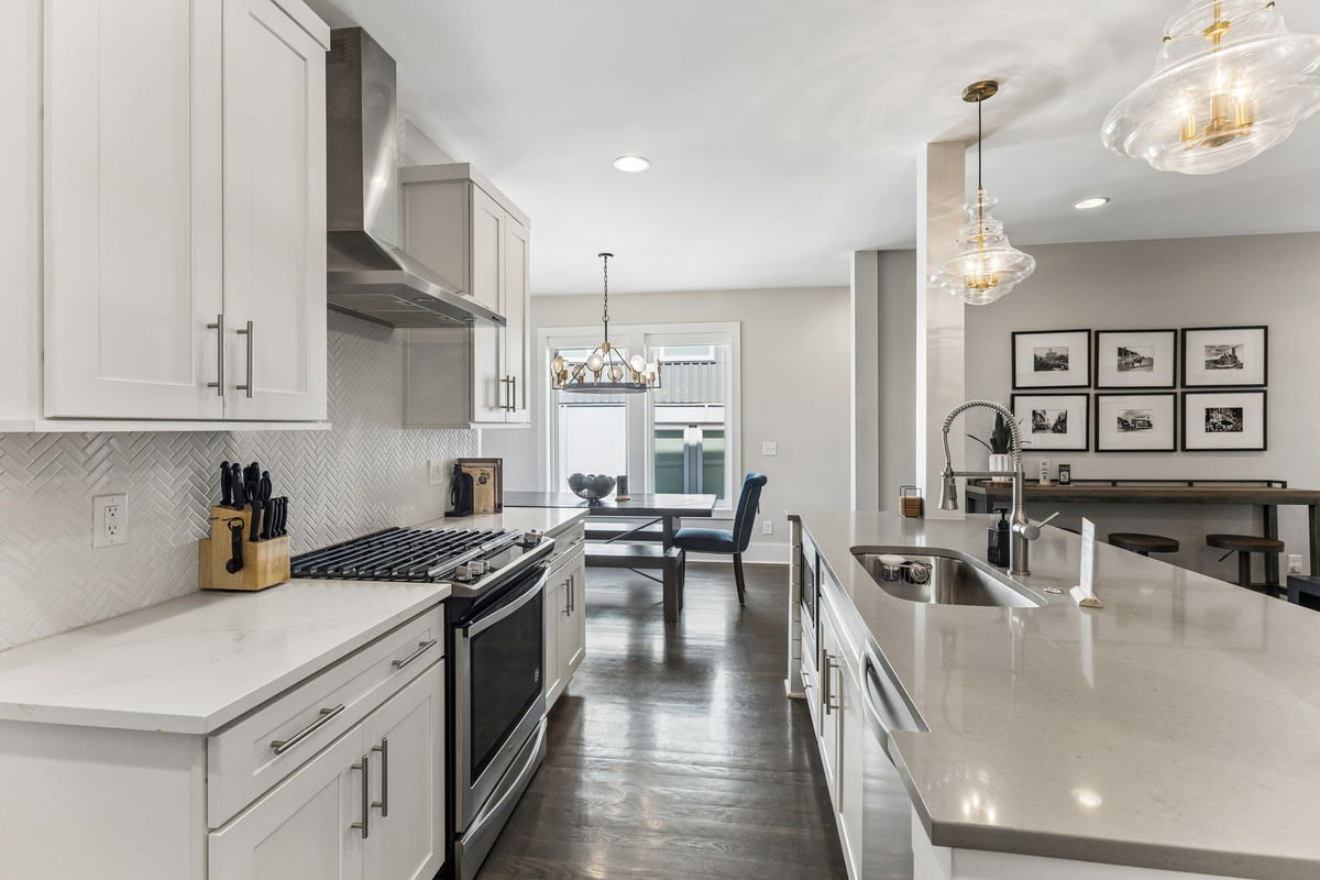 You've got a real gas range for whoever wants to cook &mdash; stainless steel burners, herringbone backsplash, and a kitchen that doesn't make you feel like you're roughing it.