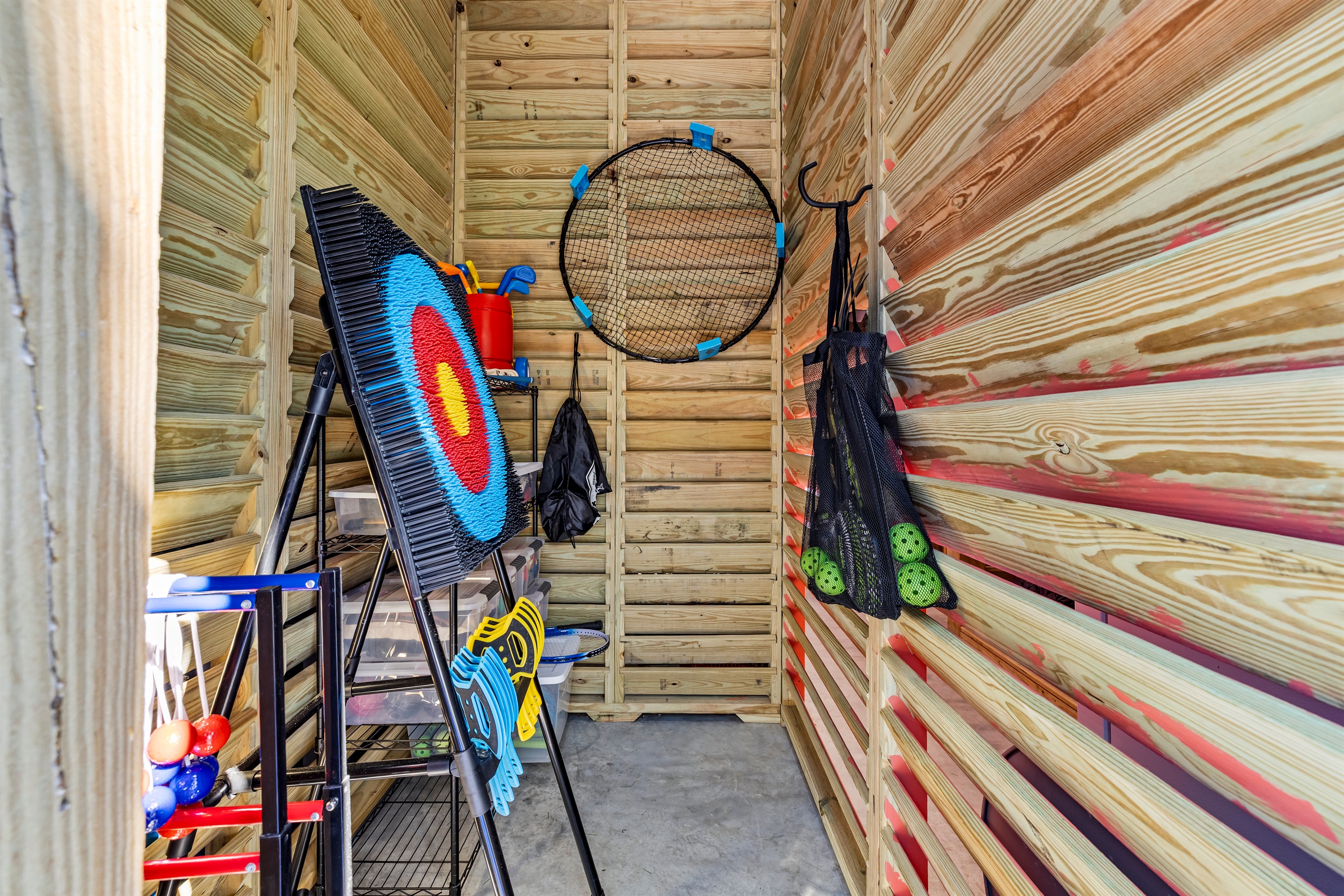 Fully stocked yard game closet including Spike Ball, Archery, Ladder Ball, Pickle ball, and Corn hole.