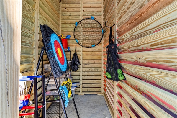 Fully stocked yard game closet including Spike Ball, Archery, Ladder Ball, Pickle ball, and Corn hole.