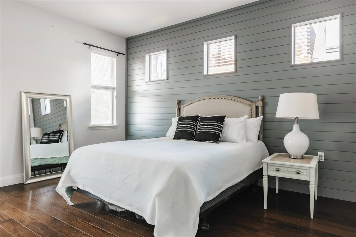 master bedroom with a king bed, a single bed