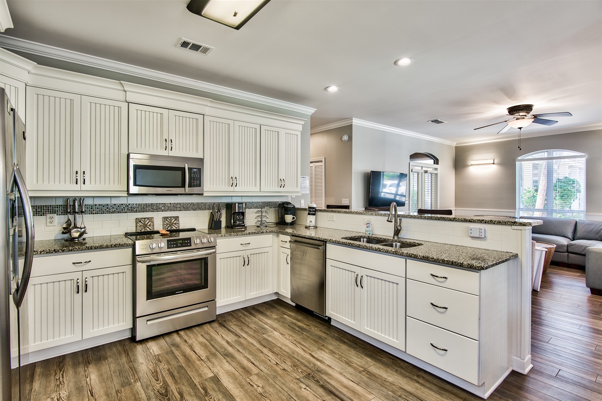 Kitchen with breakfast bar seating and open sightlines to the living room