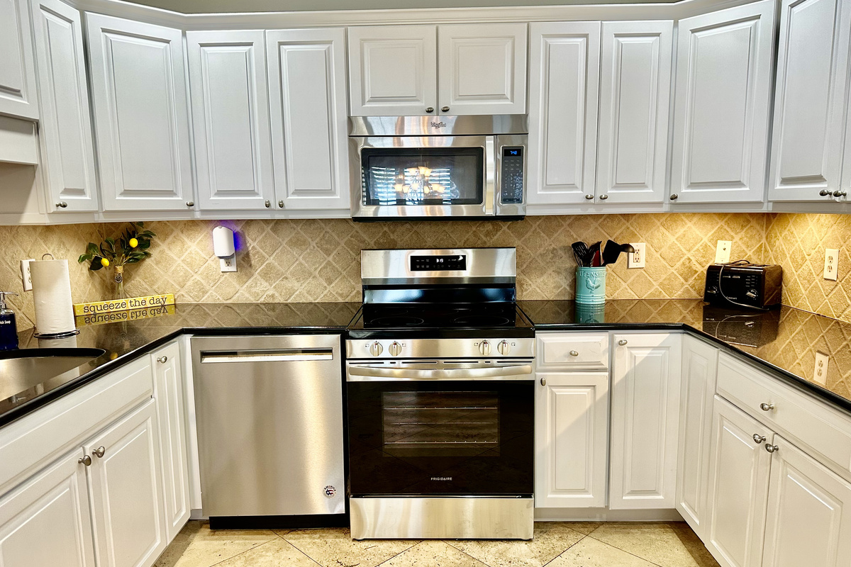 Freshly painted kitchen cabinets and a new stove/oven!