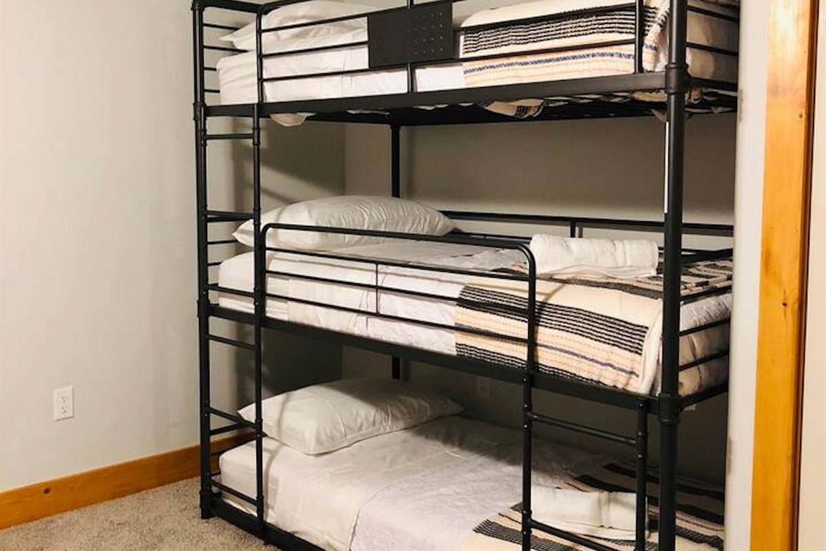 The second bedroom has six beds and extra floor space for hanging out and playing games,