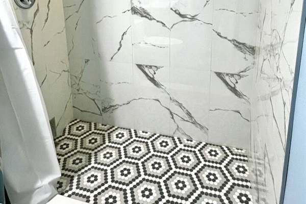 Step-in tiled shower in master bath. Shower is oversized for comfort.