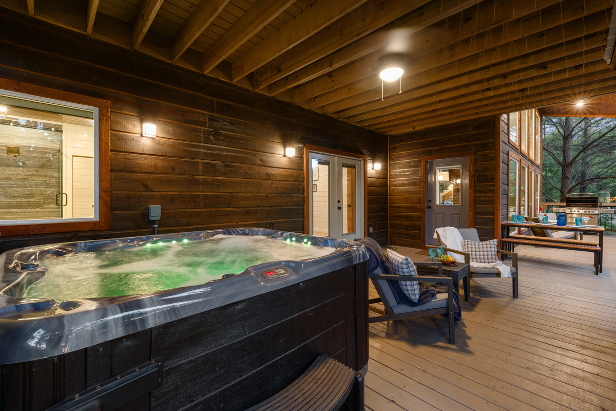 An open-air hangout built for comfort and connection — complete with a spacious dining setup, relaxed seating areas, a hot tub, fire feature, and outdoor TV for laid-back evenings under the sky. 🌙