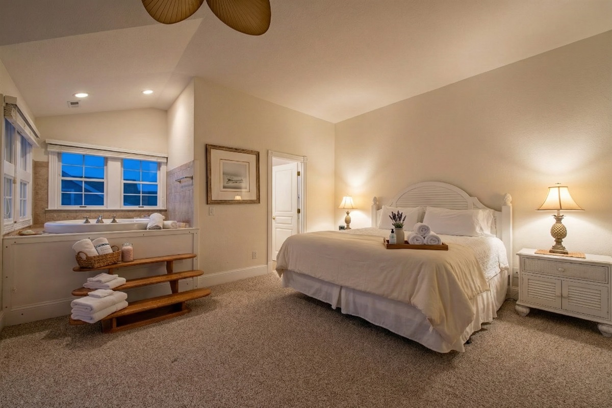 Enjoy a luxurious stay at The Hemingway's master bedroom. Equipped with two arm chairs, a dressing table, and an ensuite bathroom complete with a whirlpool, this private retreat is designed to