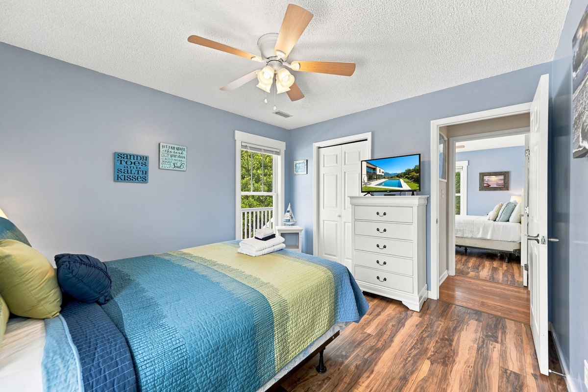 Wake up refreshed in the peaceful primary retreat complete with a Smart TV, dresser storage, and plenty of natural light